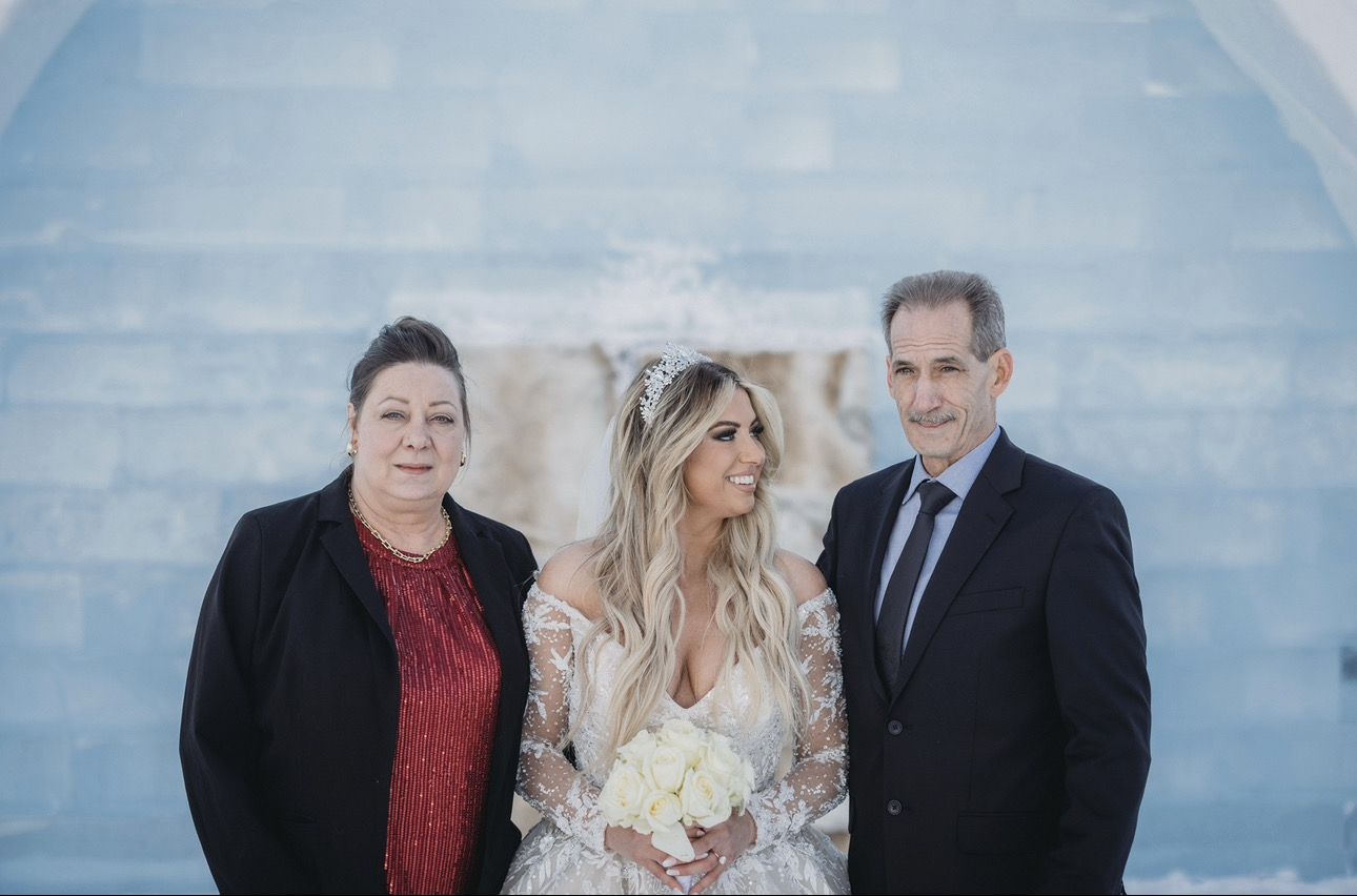 Charles and his wife with their daughter on her wedding day